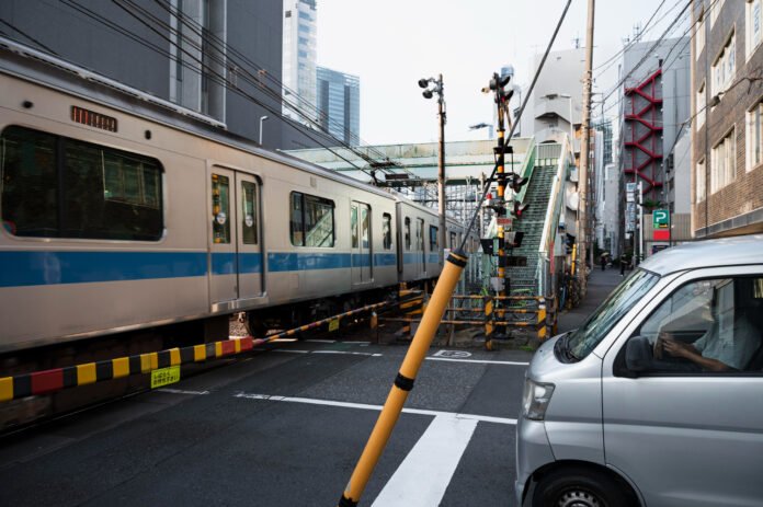 What vehicles must stop at all railroad crossings